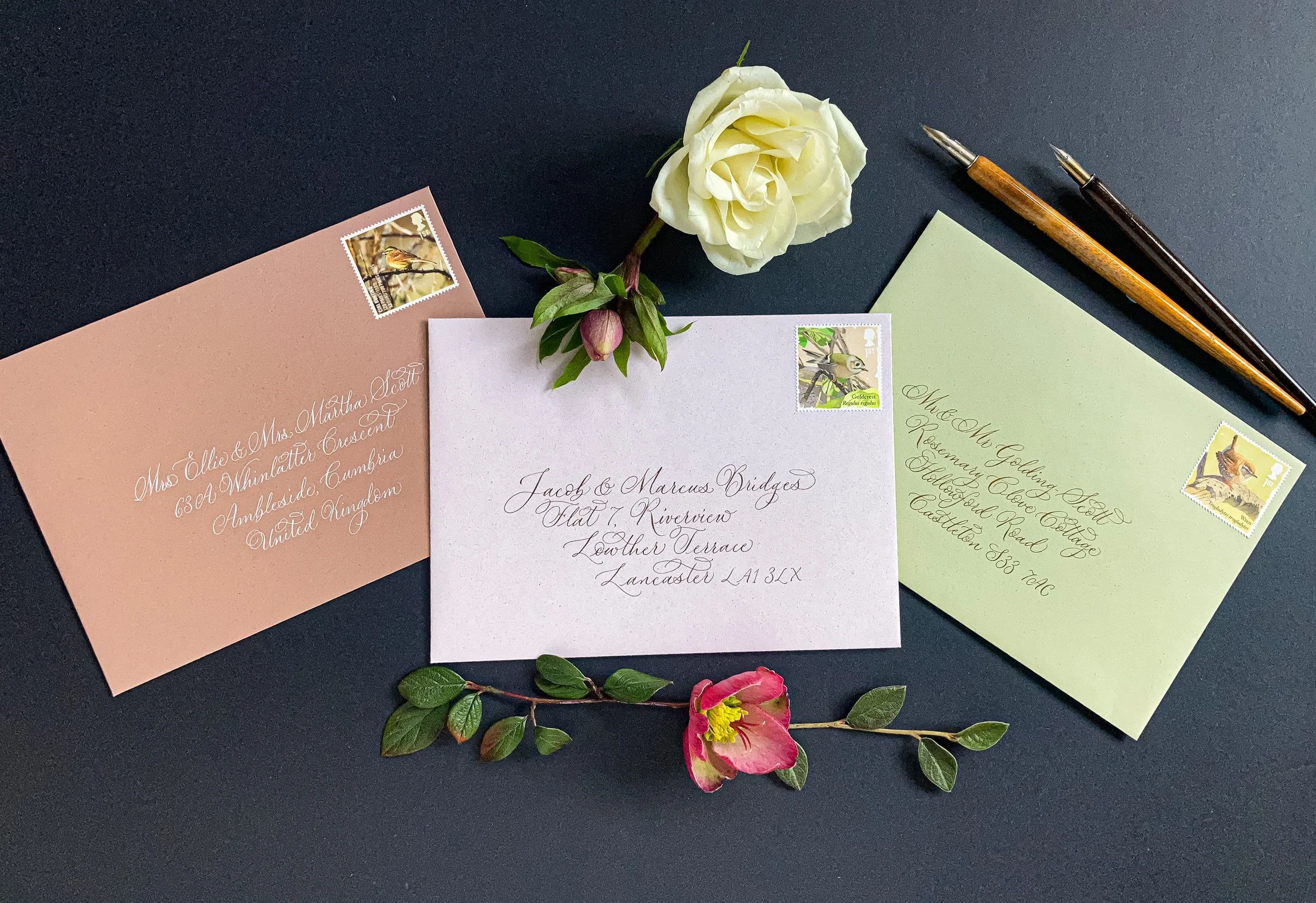 Selection of handwritten calligraphy envelopes in different colours, all with a delicate calligraphy script