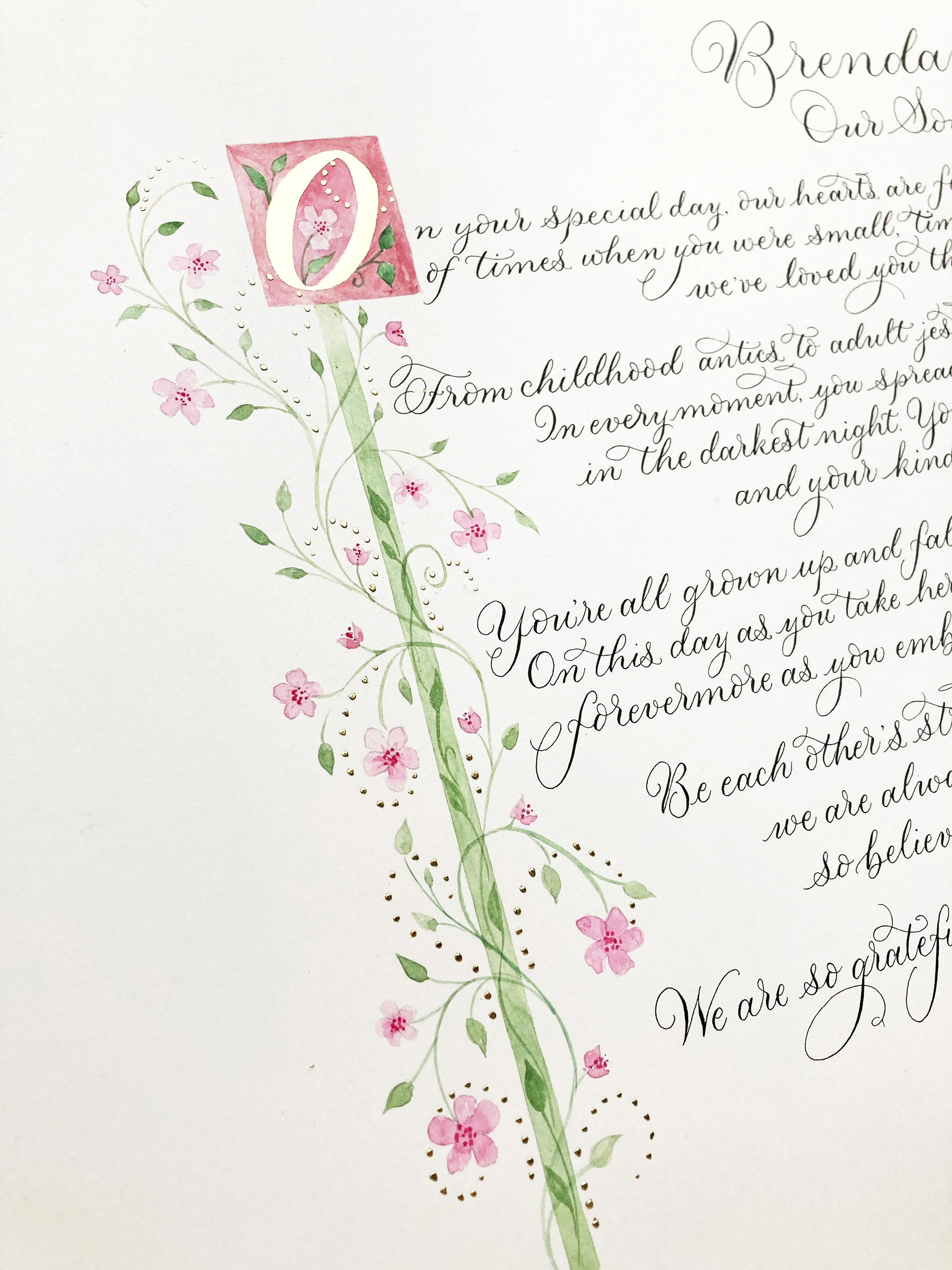 A handwritten calligraphy poem commission on white paper with a decorative pink and green floral design and 23 carat gilded letter 'O' at the top, addressed to Brenda, expressing love and appreciation.