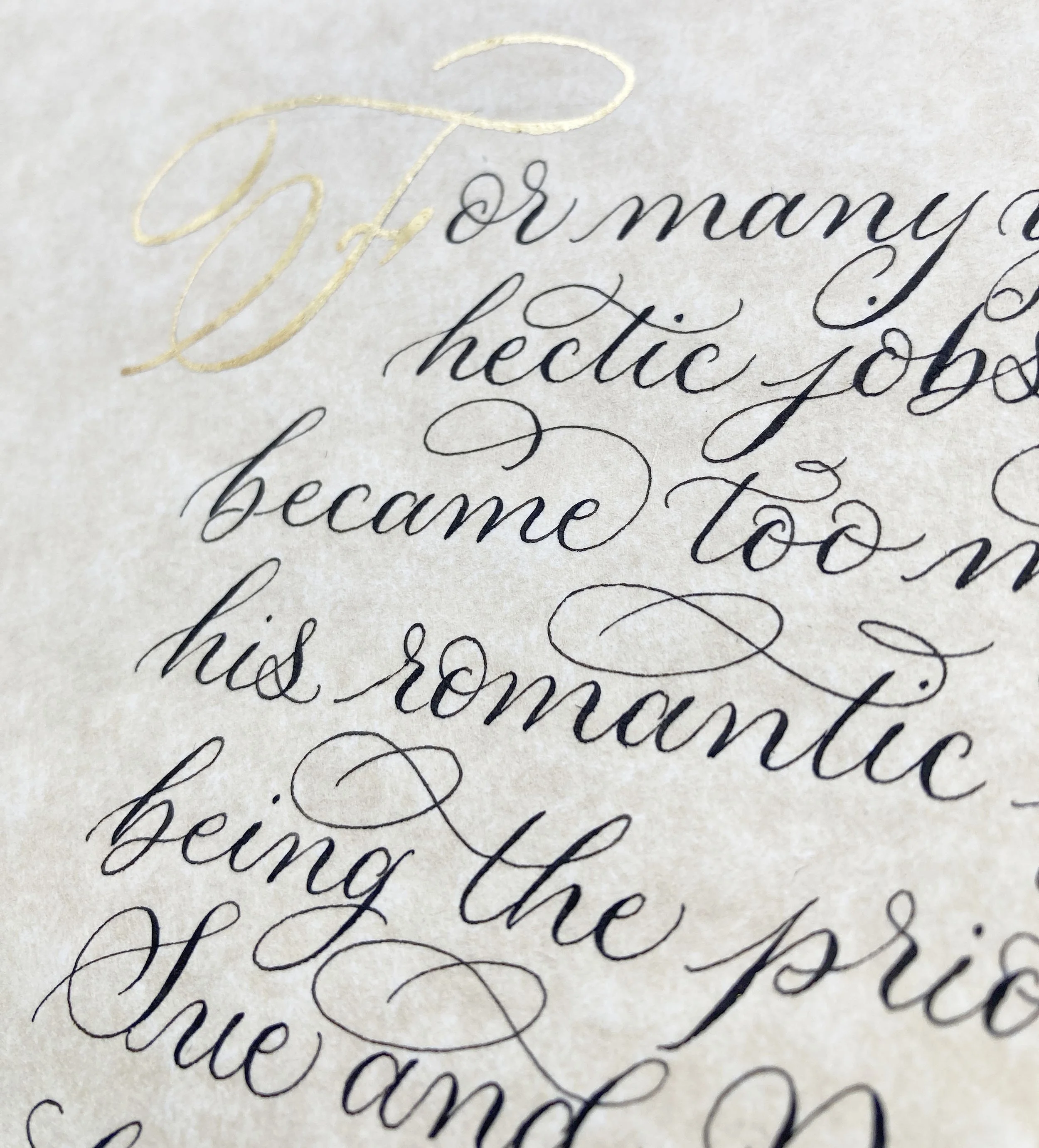 Calligraphy commission close up with gold leaf initial letter