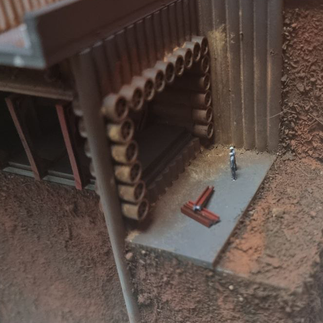 Close-up of a construction site with a concrete slab, metal rebar, and hollow clay blocks creating a wall or structure frame.