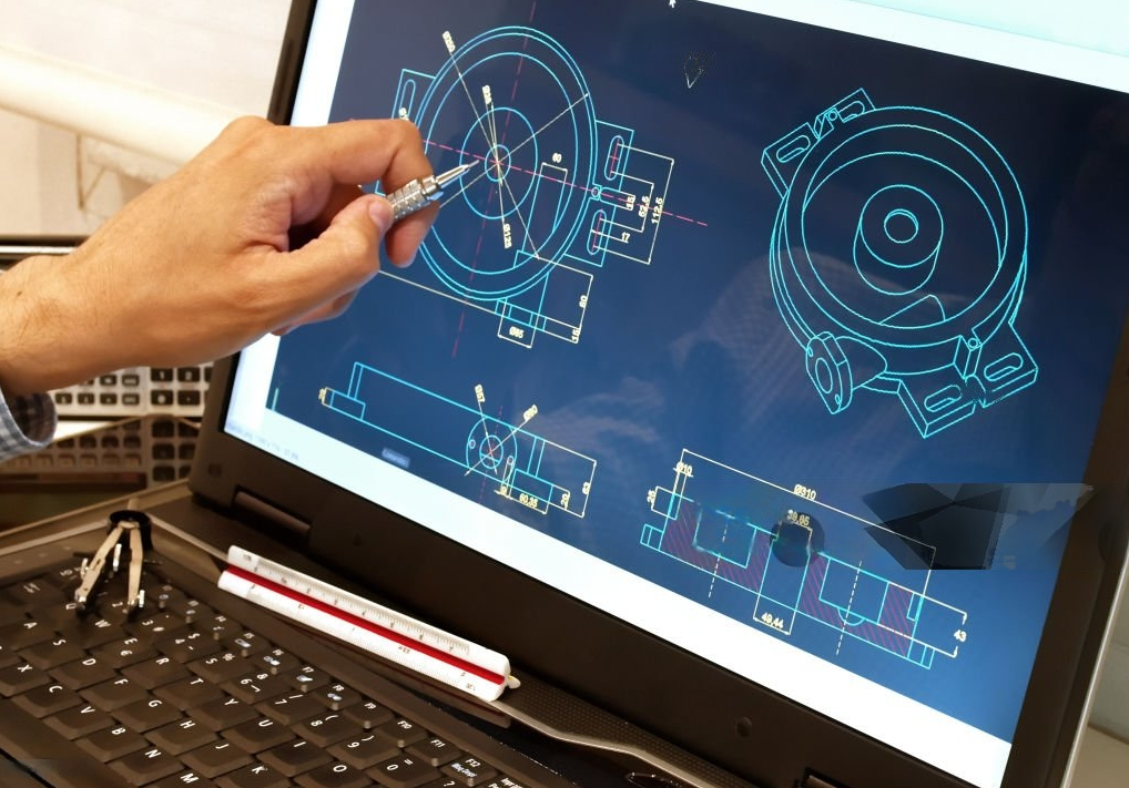 Person working on mechanical engineering drawings of a circular device on a computer screen, with drafting tools on the keyboard.