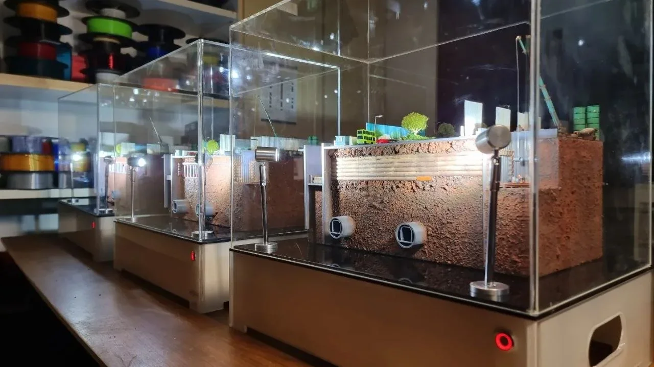 Models of underground subway and tunnel systems with detailed excavations and infrastructure, encased in glass display cases.