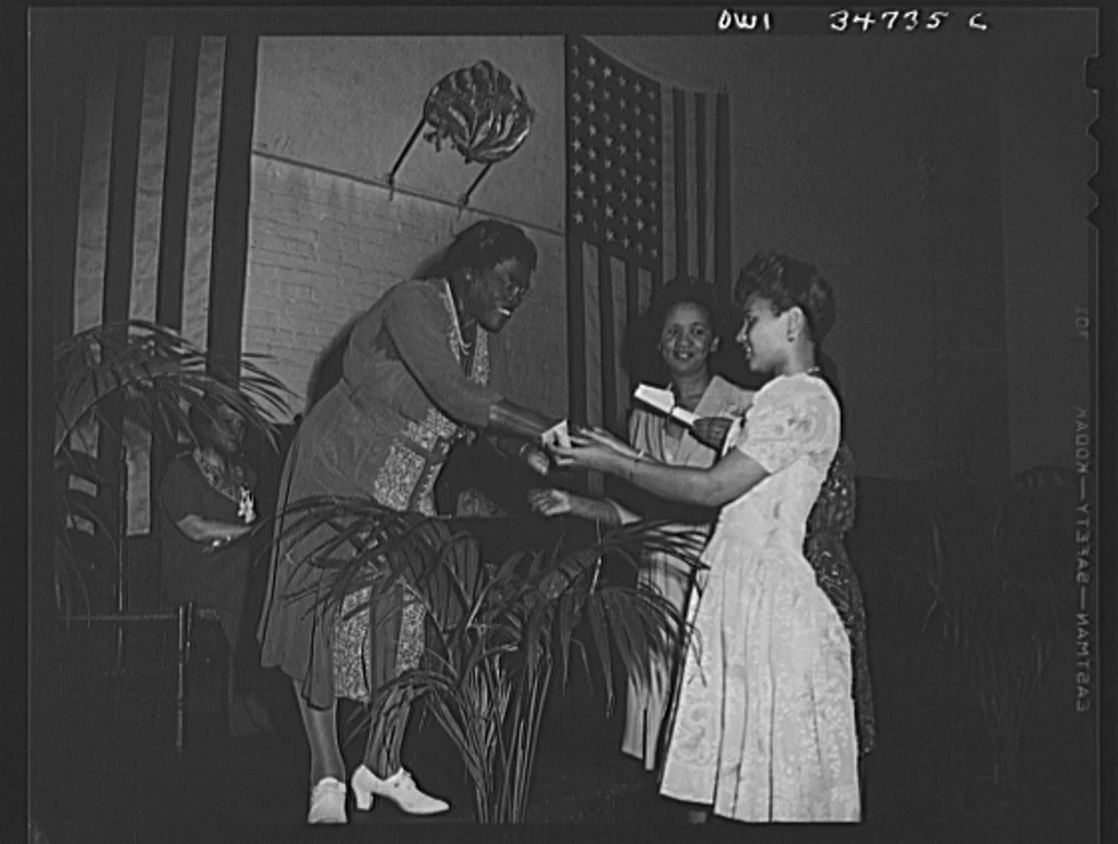 Bethune presenting a certificate to Miss Dorothy Height, Director of the YWCA