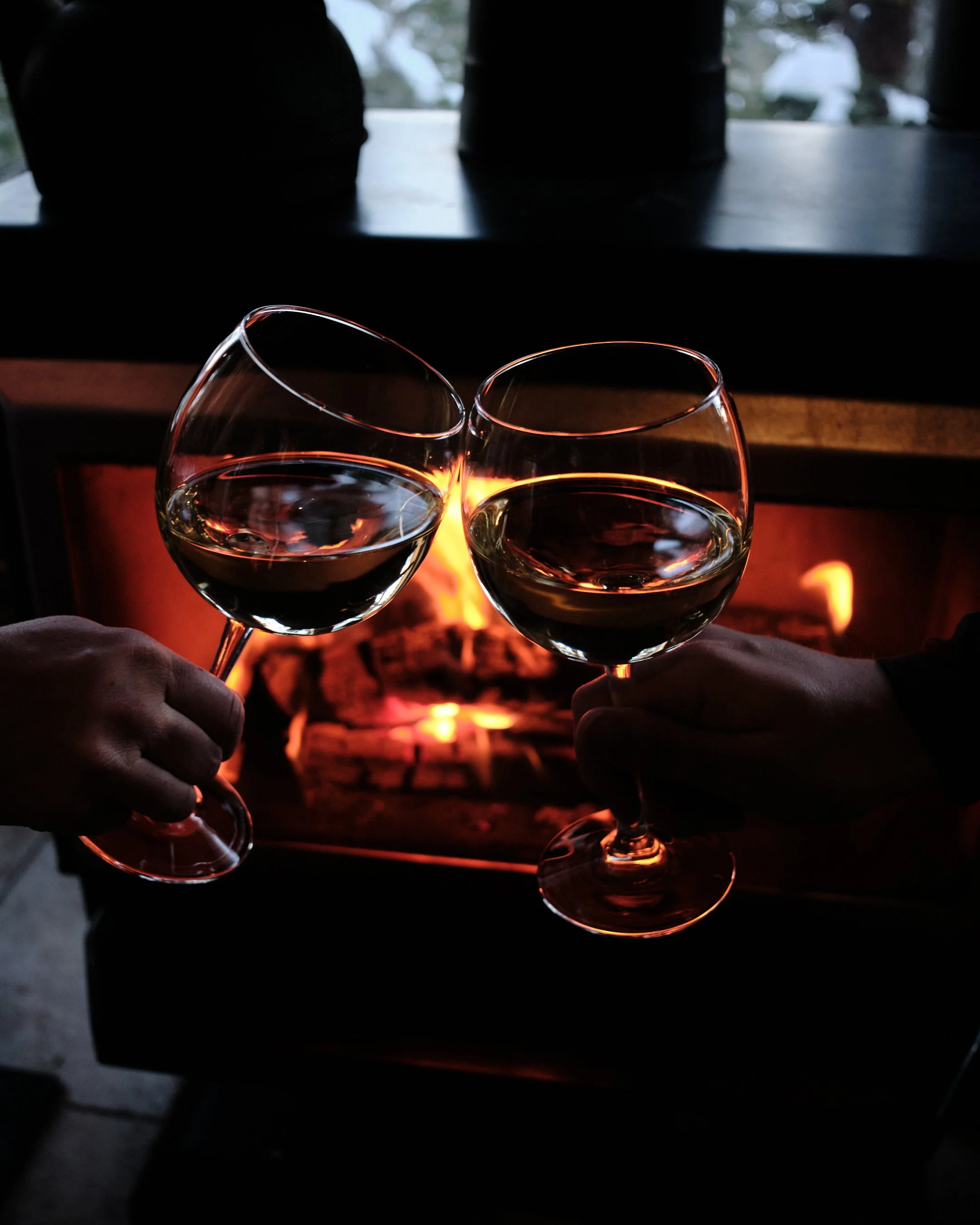 Wine toast photography in moody lighting by Los Angeles beverage photographer Matt Francisco