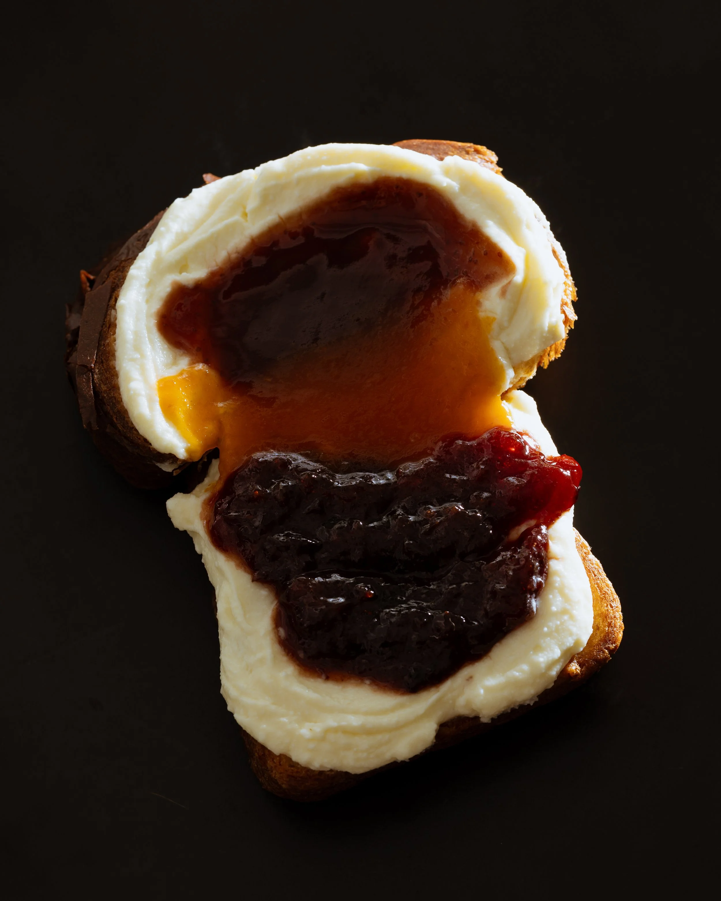 Sqirl famed ricotta toast food photography on black background by Los Angeles food photographer Matt Francisco