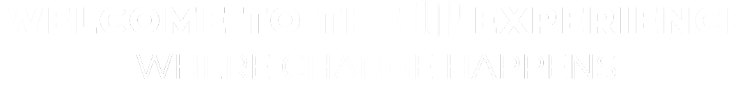 Welcome sign for the 'XP Experience' with the slogan 'Where Change Happens' in black and white.