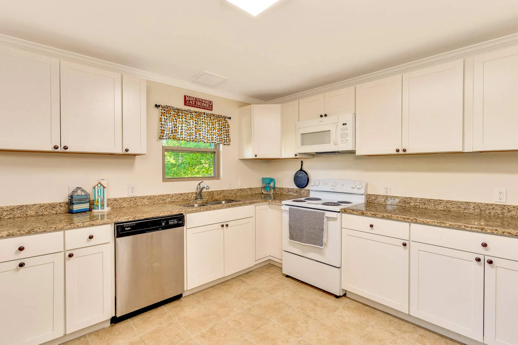Updated kitchen with granite counters and white shaker cabinets