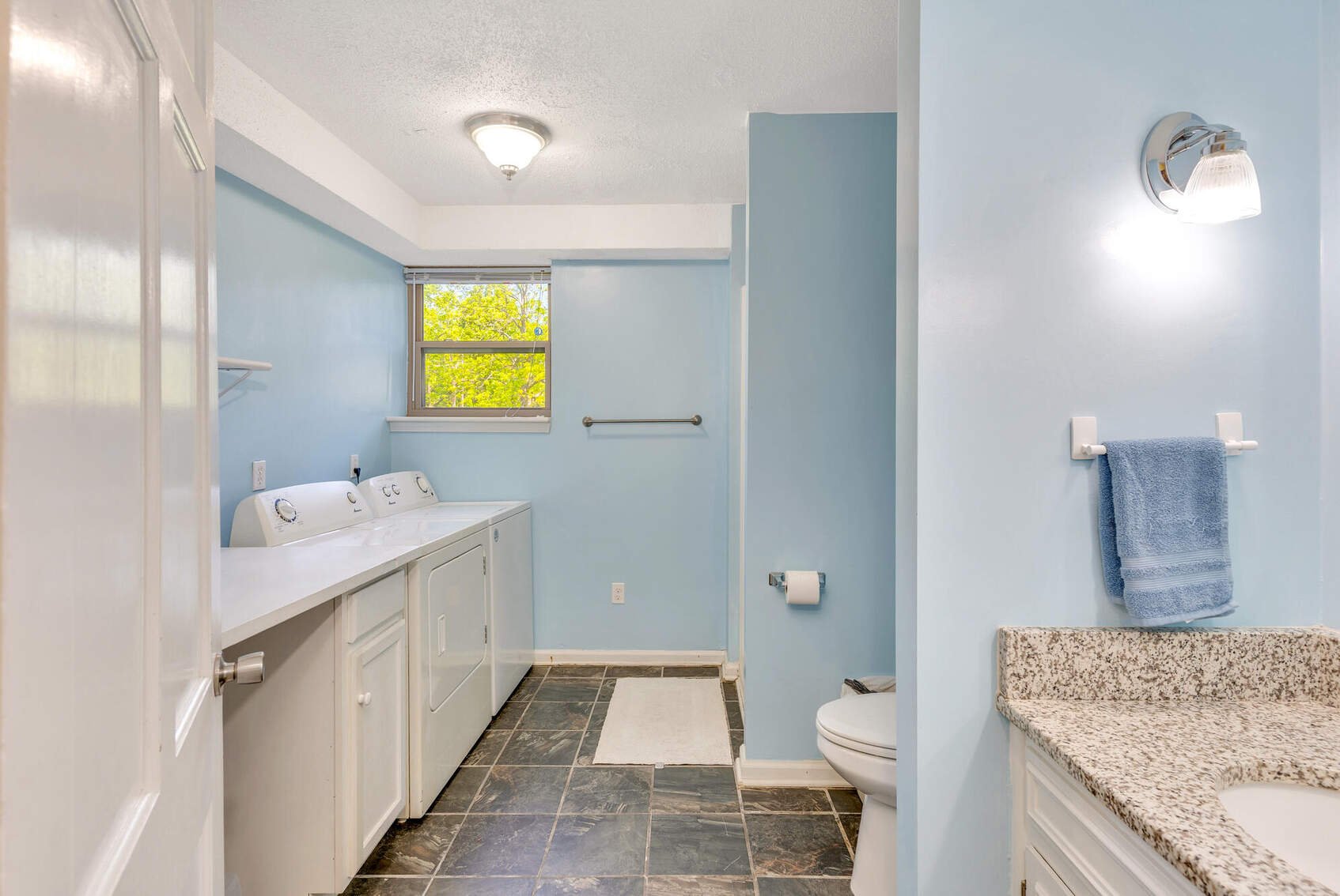 Basement full bath with washer, dryer and laundry counter