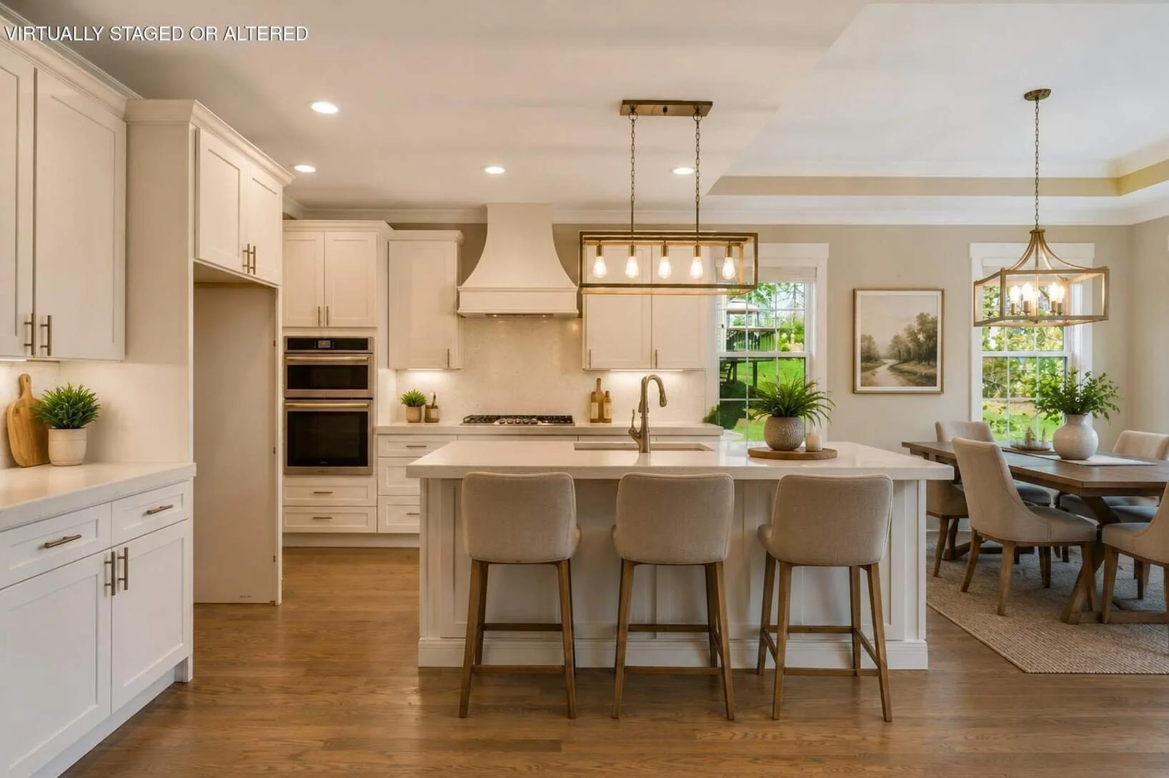 Kitchen with island, double wall ovens, gas cooktop and range hood, virtually staged
