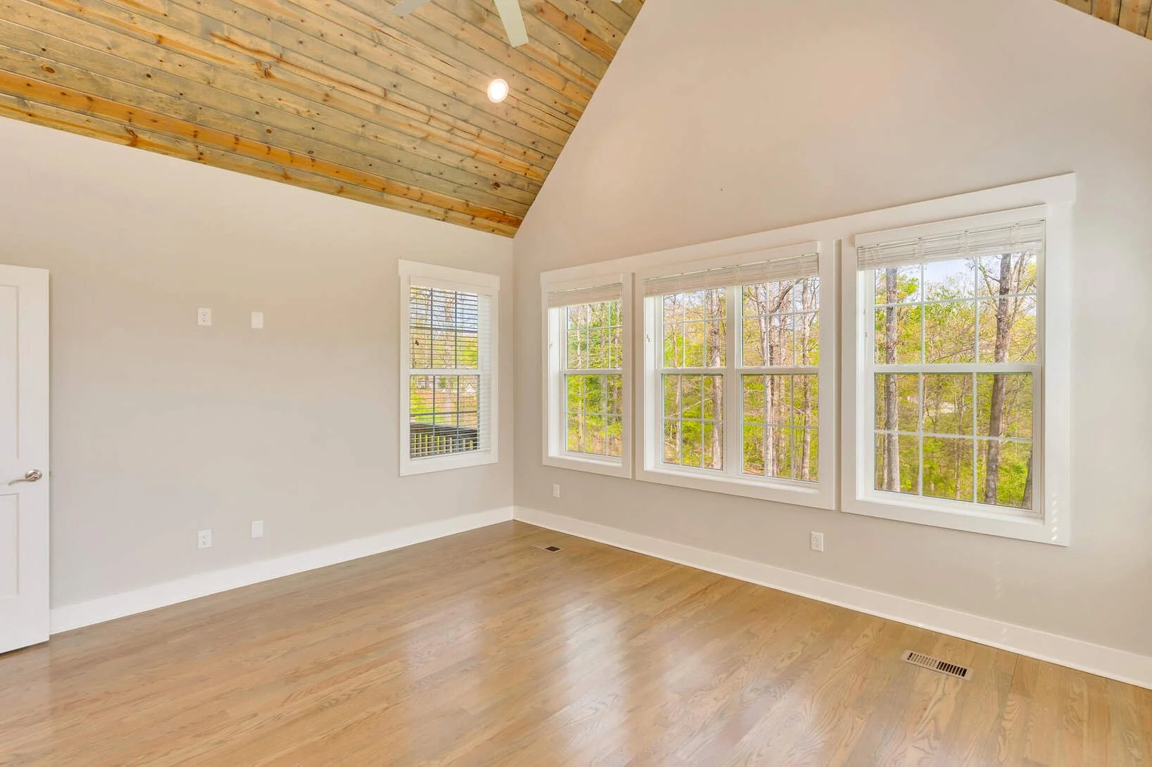 Primary bedroom windows overlooking the trees