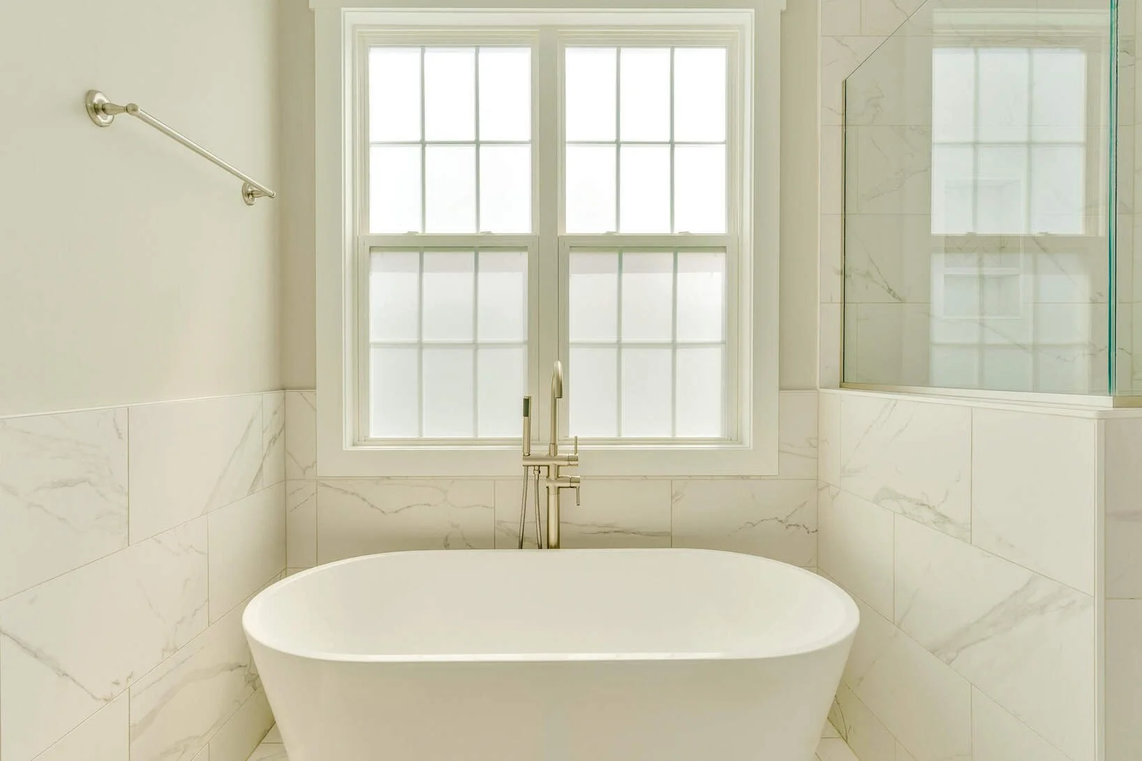Freestanding soaking tub and glass shower in the primary bath