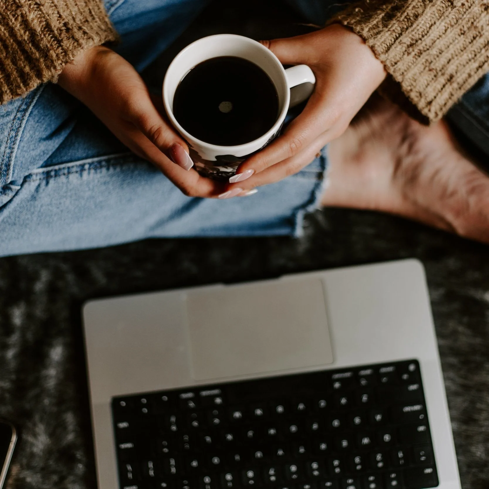 Laptop and a hot drink in hand