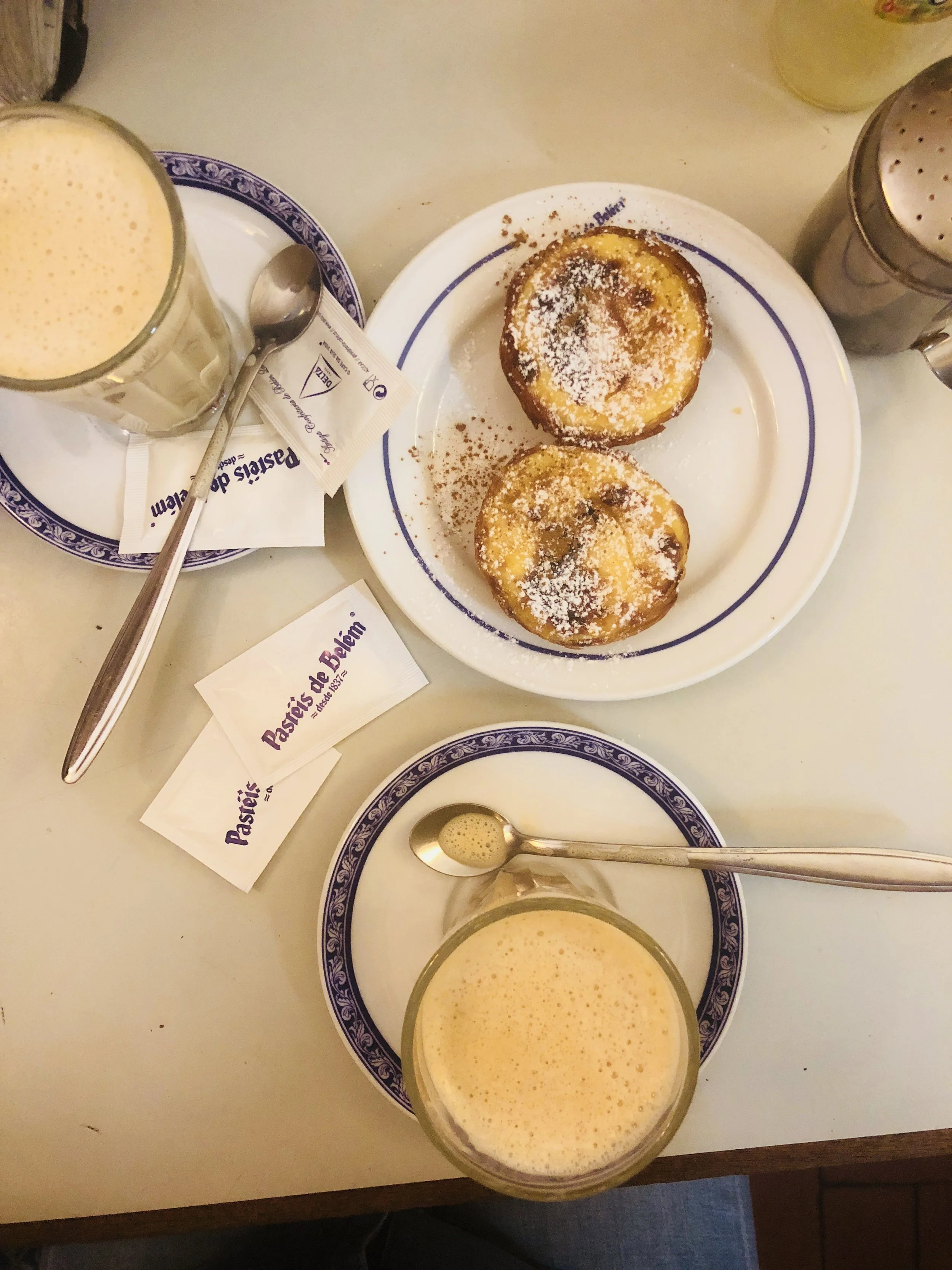 Flat lay of food from Pasteis de Belem
