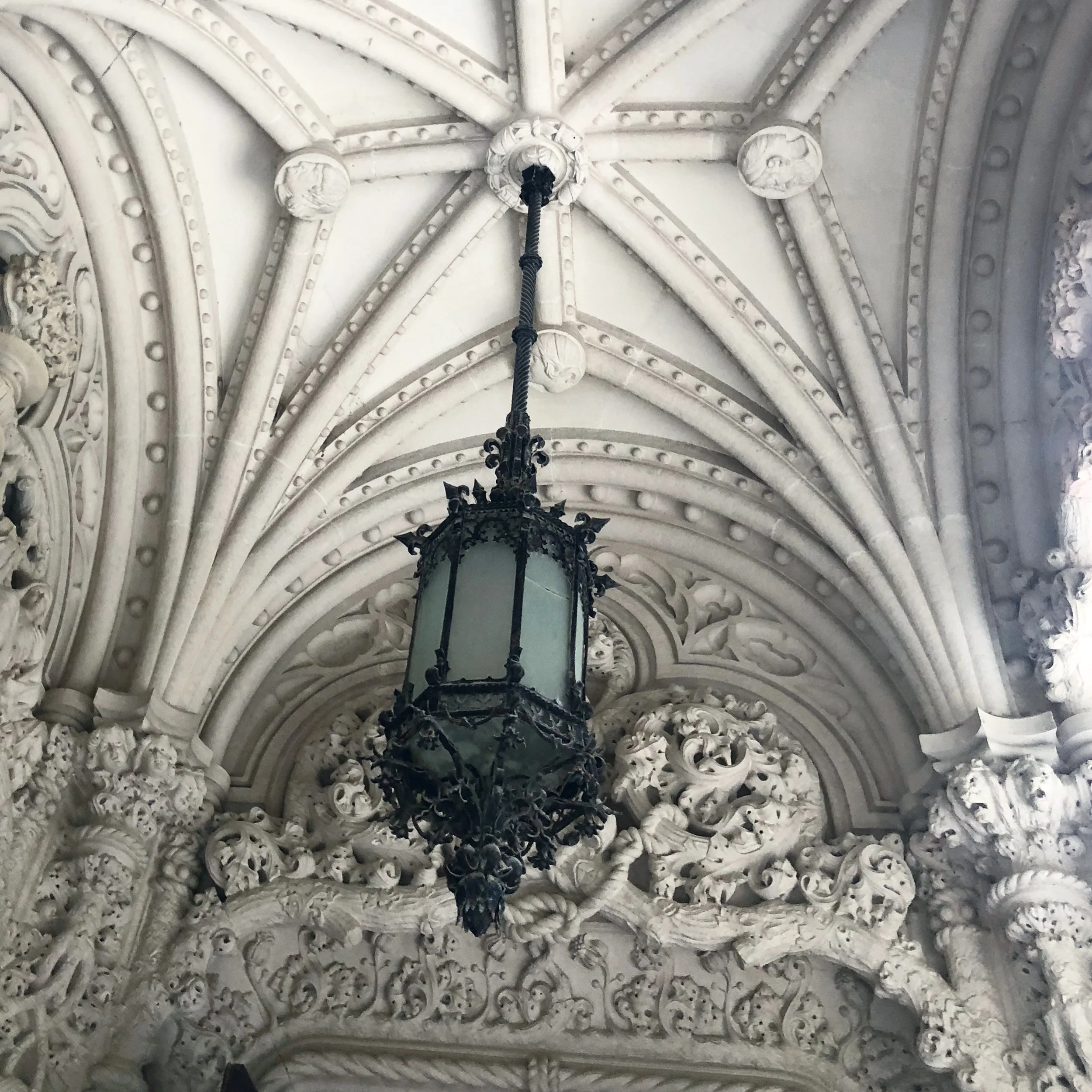 Ceiling of Quinta Da Regaleira with old wrought iron lamp