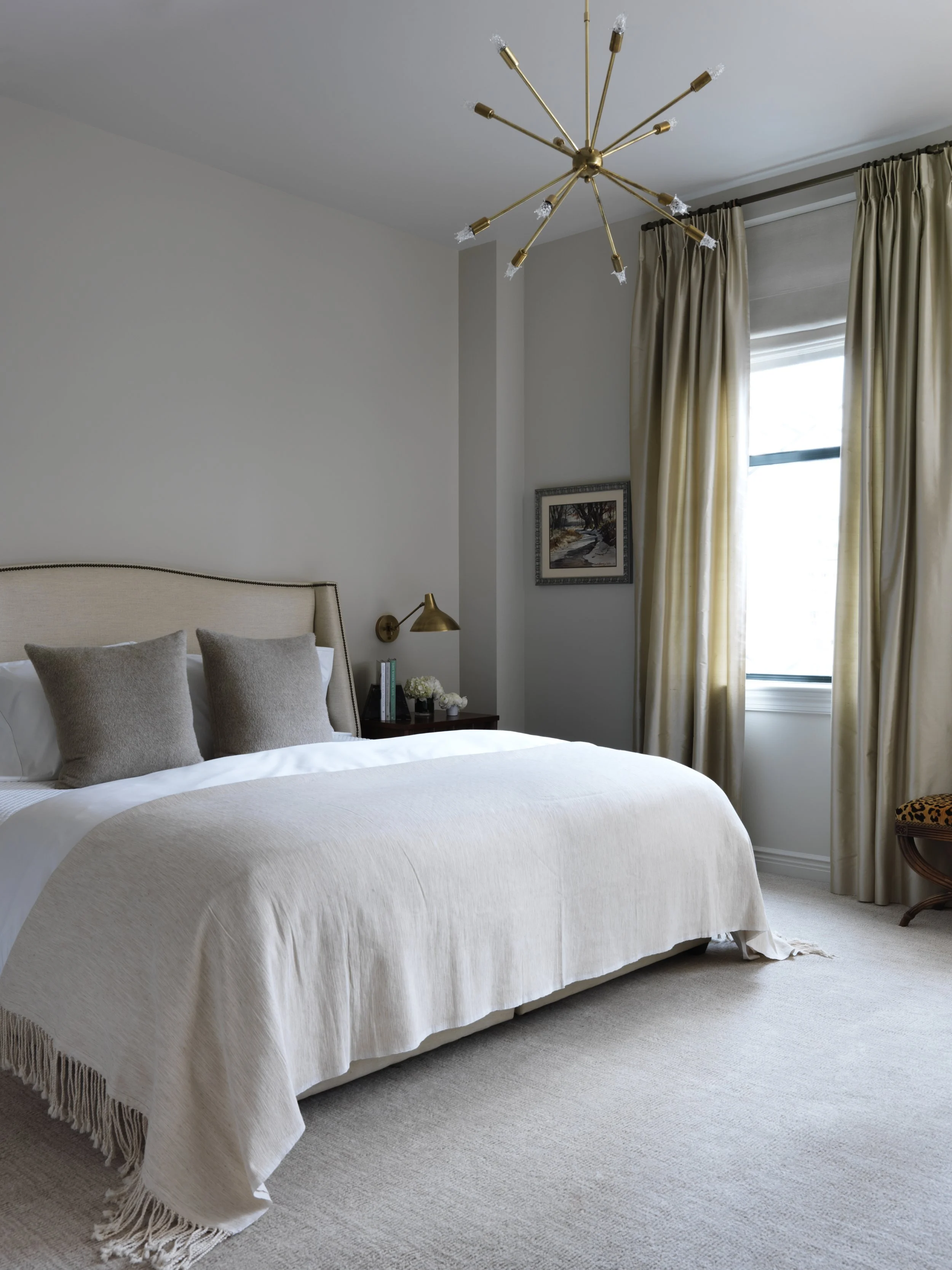 Bedroom design by Elaine Santos Design featuring brushed brass chandelier and bedside lamp