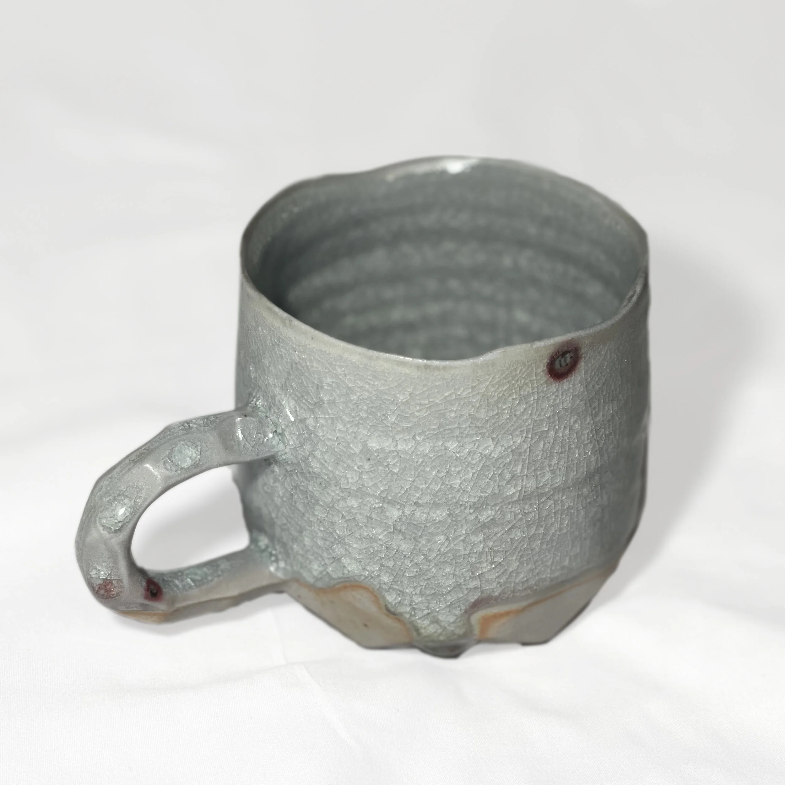 porcelain cup with faceted base and handle.jpg