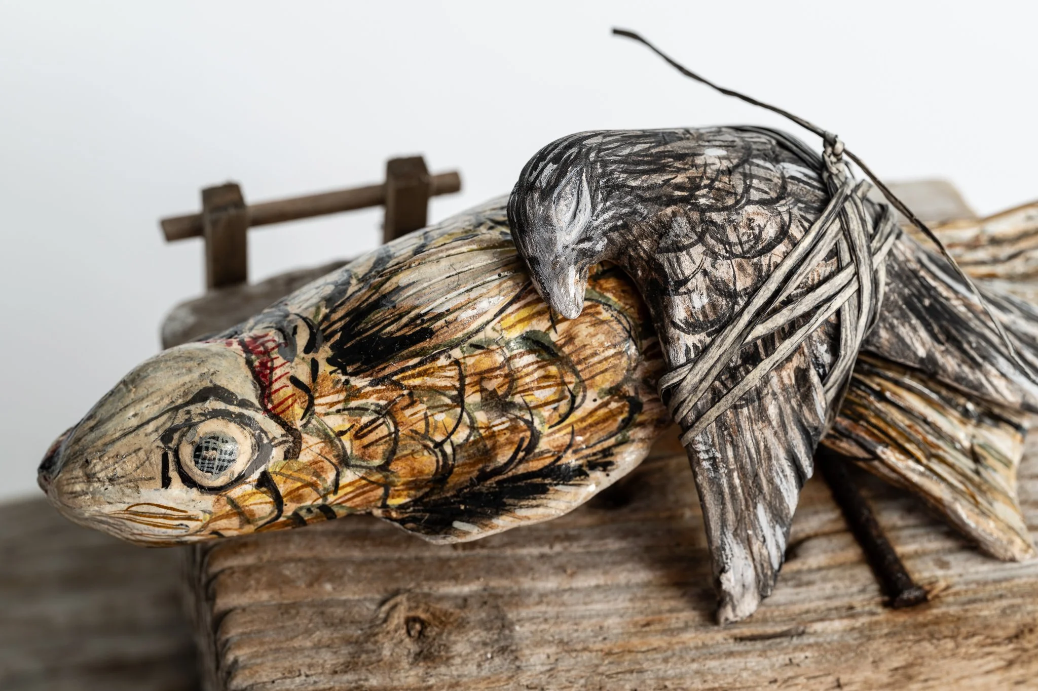 How the fish saved the sparrow from drowning, 2023, H7.375 x W5.25” x L10.5, wood, paperclay, wire mesh, gouache, hemp twine, varnish