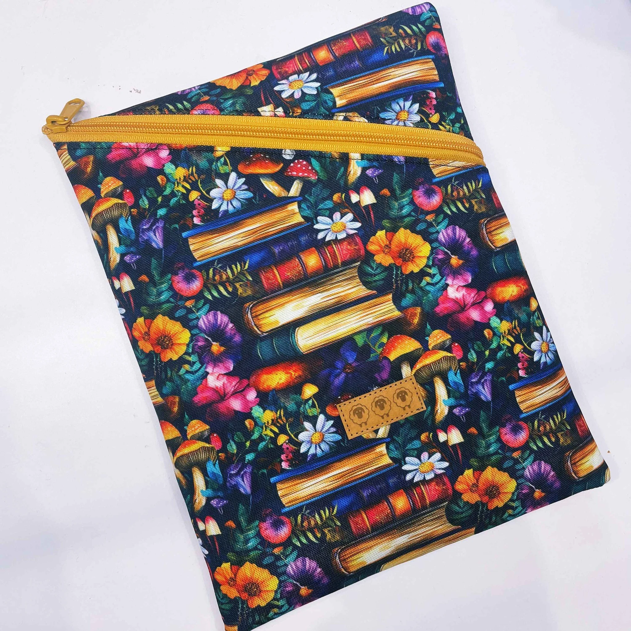 Book Sleeve that is:
•water resistant, 
•padded for protection 
•large enough for a trade paperback / kindle / iPad 11"