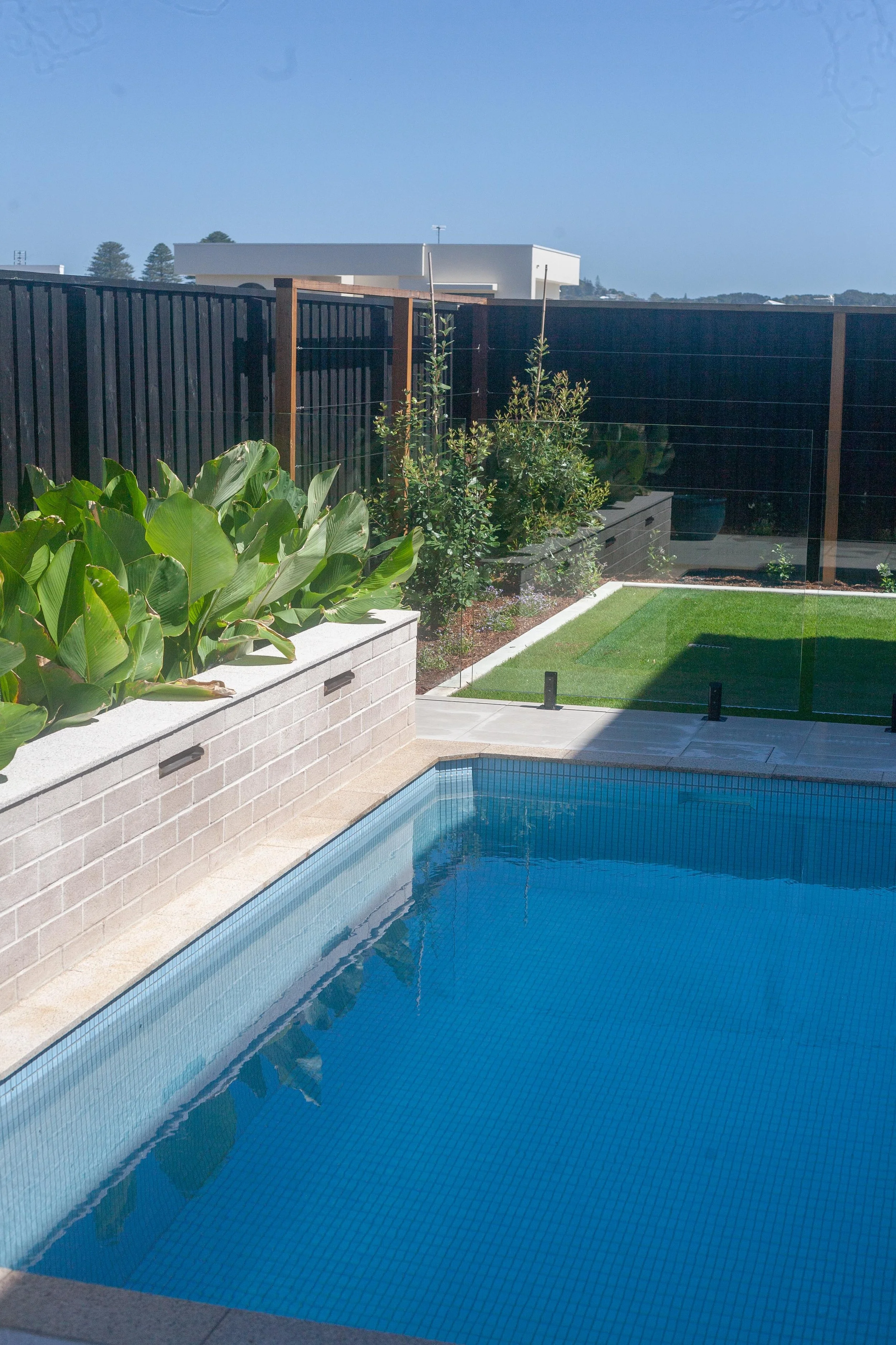 Plunge pool with a feature fountain wall behind.