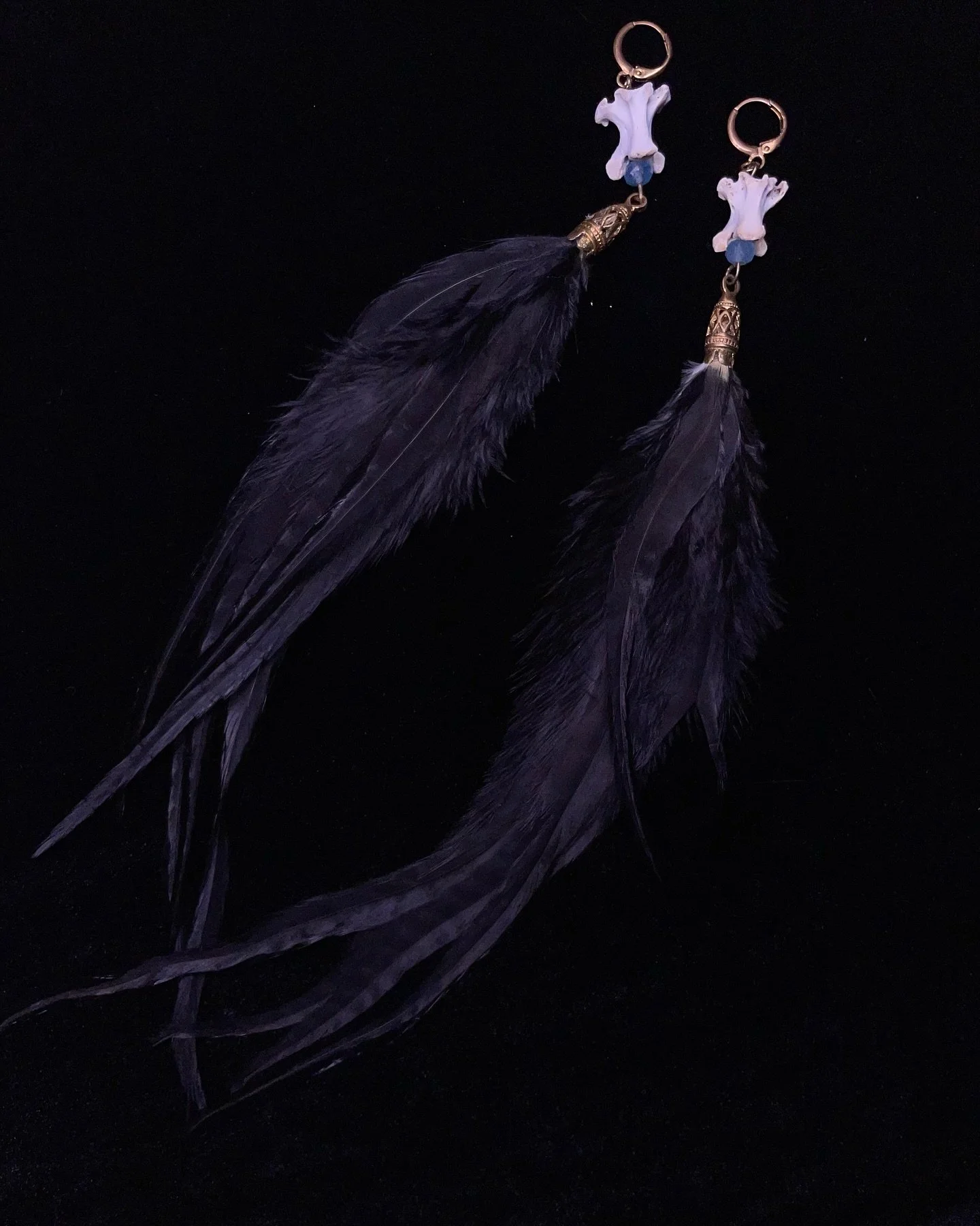 Earrings available next weekend at the Calgary tattoo festival October 18 - 20th @veil.of.the.moon 🖤 Raven veterbre with aquamarine crystal and black feathers 🪶 All animal artifacts are ethically sourced 🖤 #airdrietattoo #airdriebusiness #calgaryt