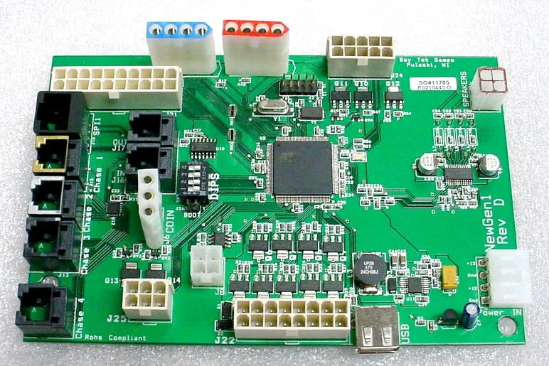 Green printed circuit board with various black, white, and colored connectors, chips, and electronic components.