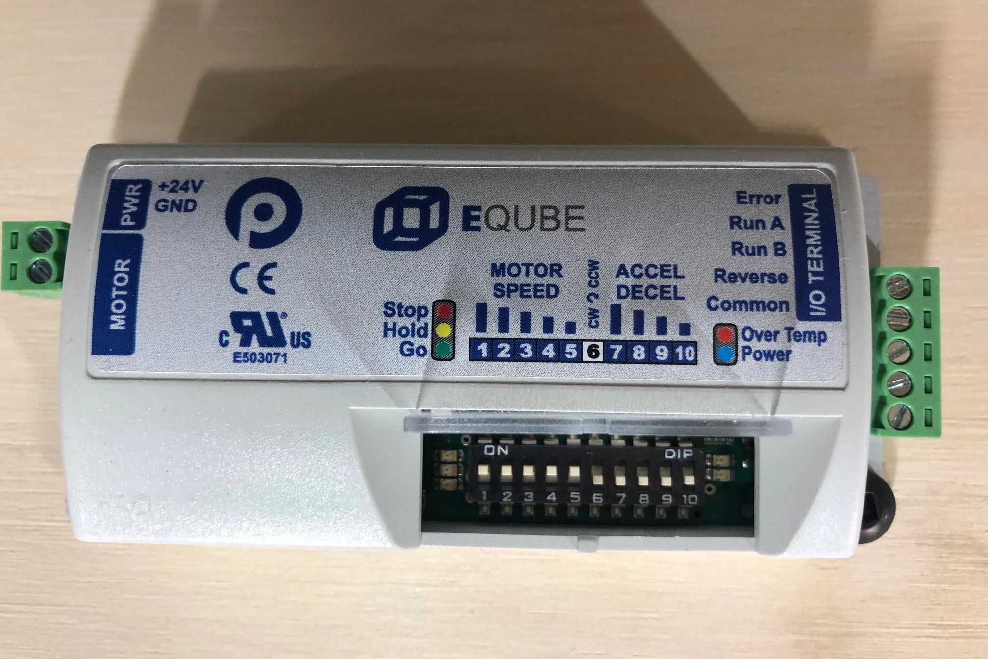 A gray electronic motor controller with various labeled connectors, status indicators, and controls for motor speed, direction, and error reporting.