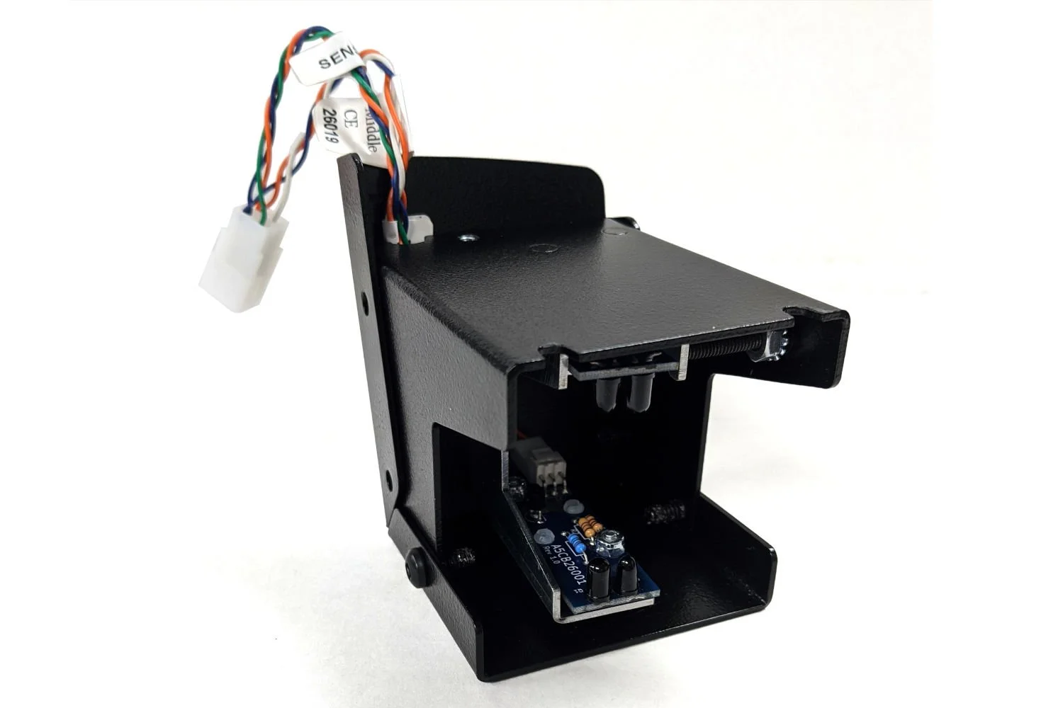 Black electronic device with circuit board and multicolored wires attached.