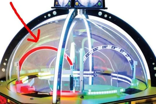 A futuristic indoor skydiving simulator with a transparent vertical tunnel surrounded by LED lights.