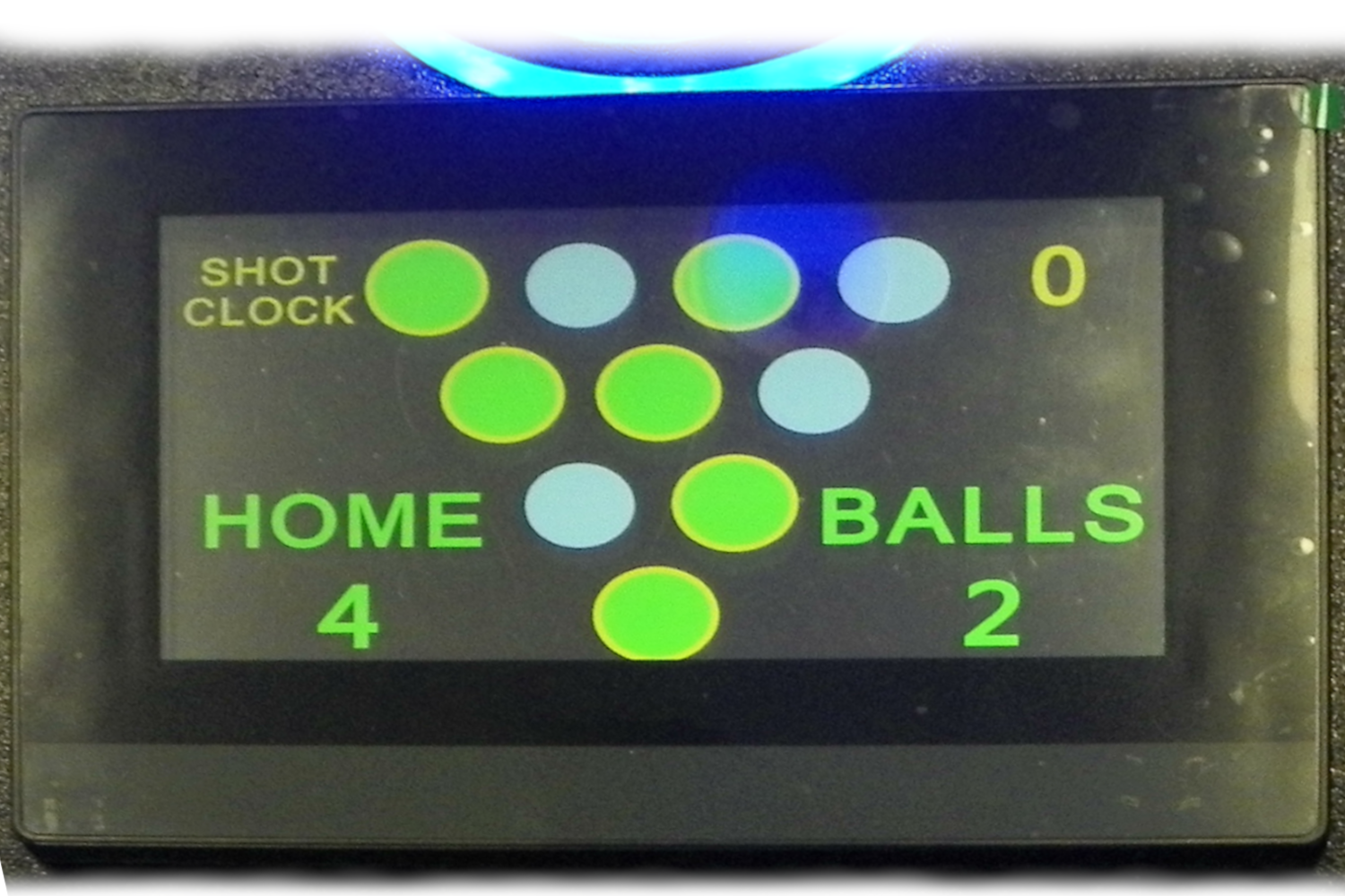 Digital scoreboard displaying a game, with the words "HOME" and "BALLS", the score "4" for home and "2" for balls, and various colored circular indicators.
