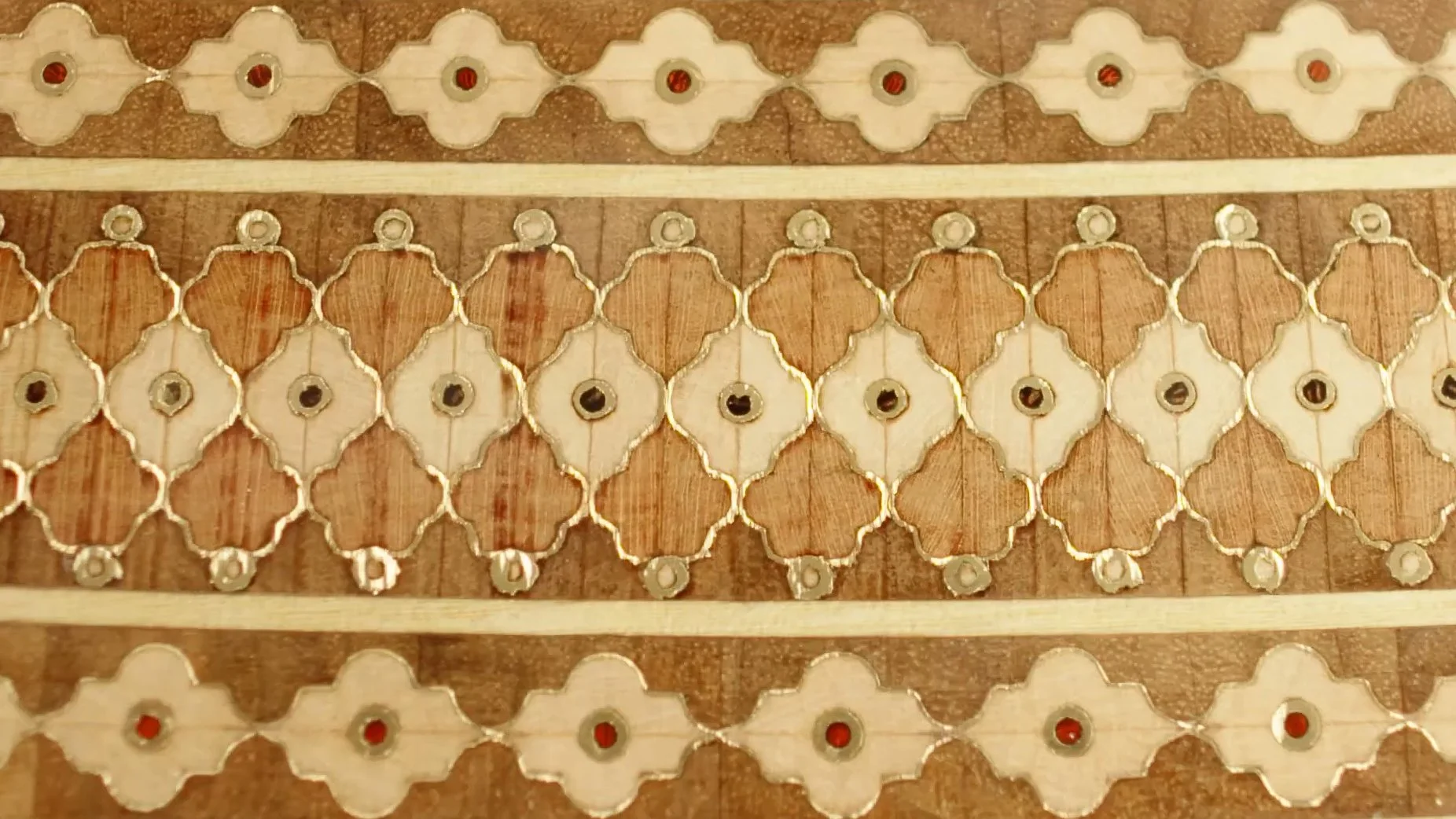 Close-up of traditional Persian marquetry design with intricate geometric patterns and wooden inlays.