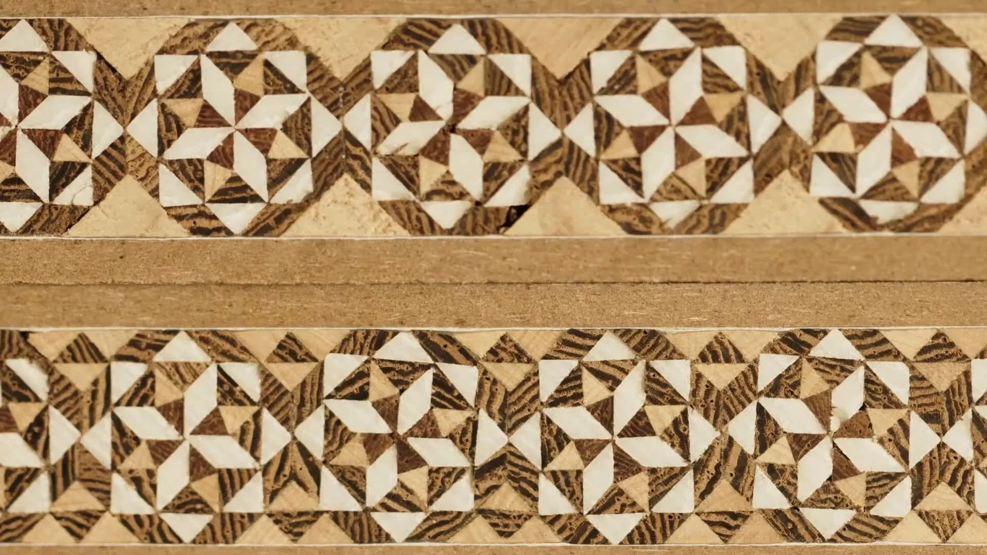 Wooden mosaic pattern with geometric star shapes