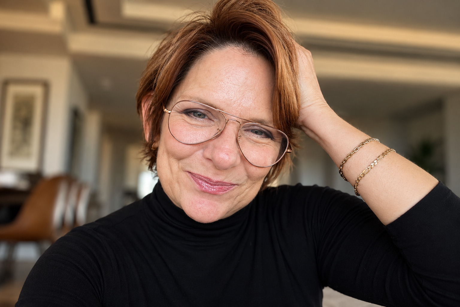 Jill Hoffman (Jill Rutan Hoffman), author and keynote speaker, smiling in glasses and a black turtleneck