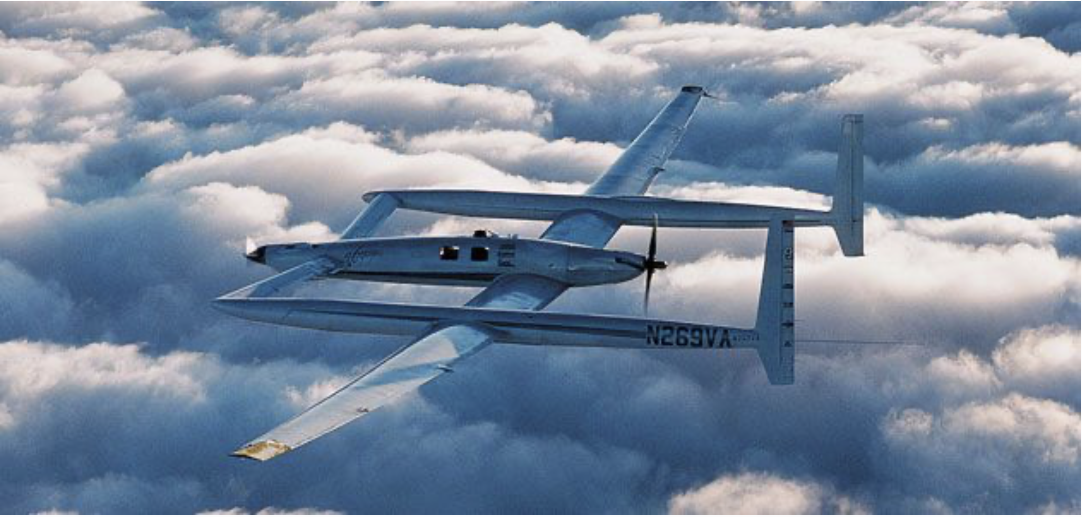 Dick Rutan's Voyager world flight aircraft flying above clouds.