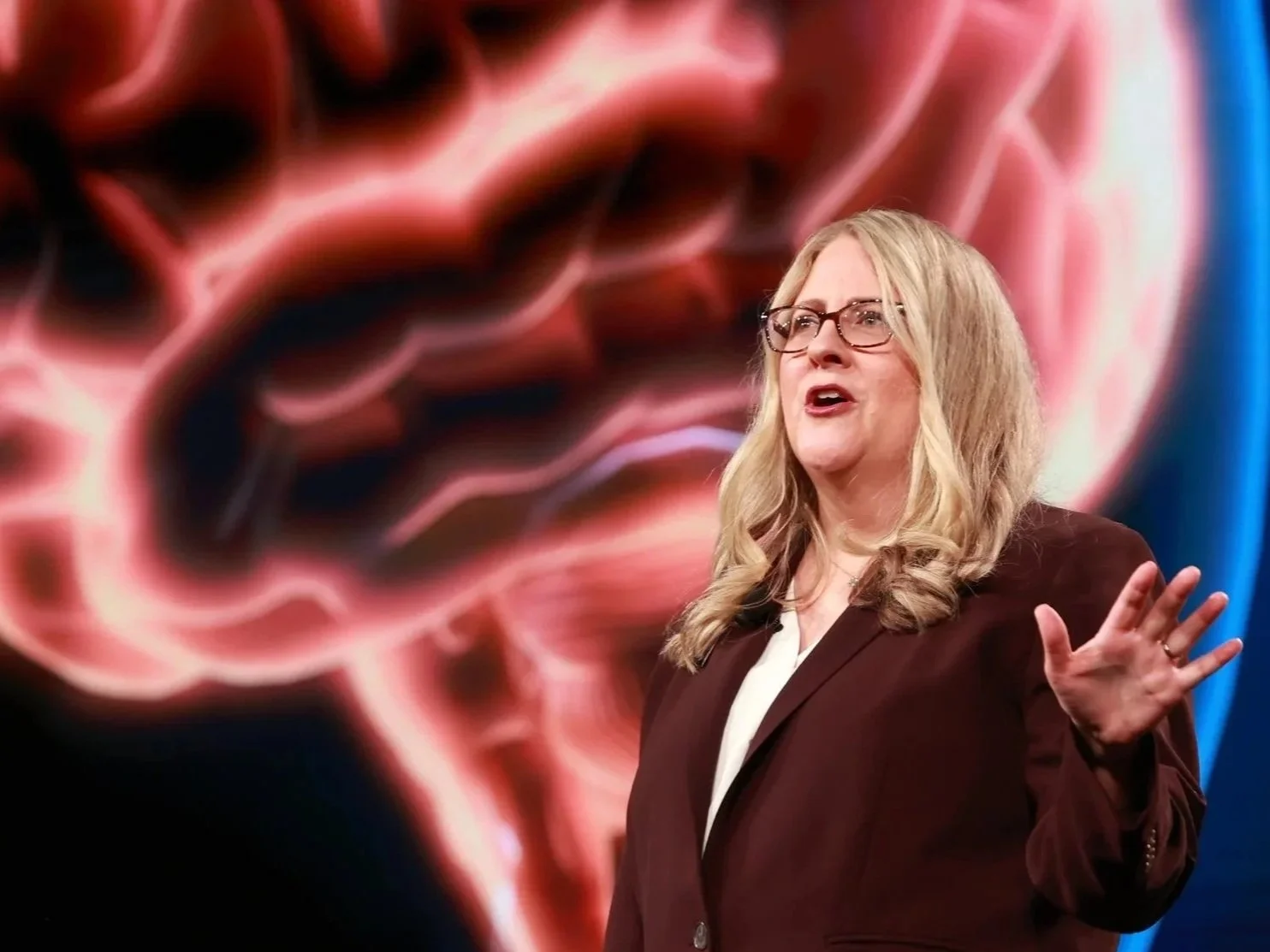 Karen Eber describing the Five Factory Settings of the Brain during a keynote