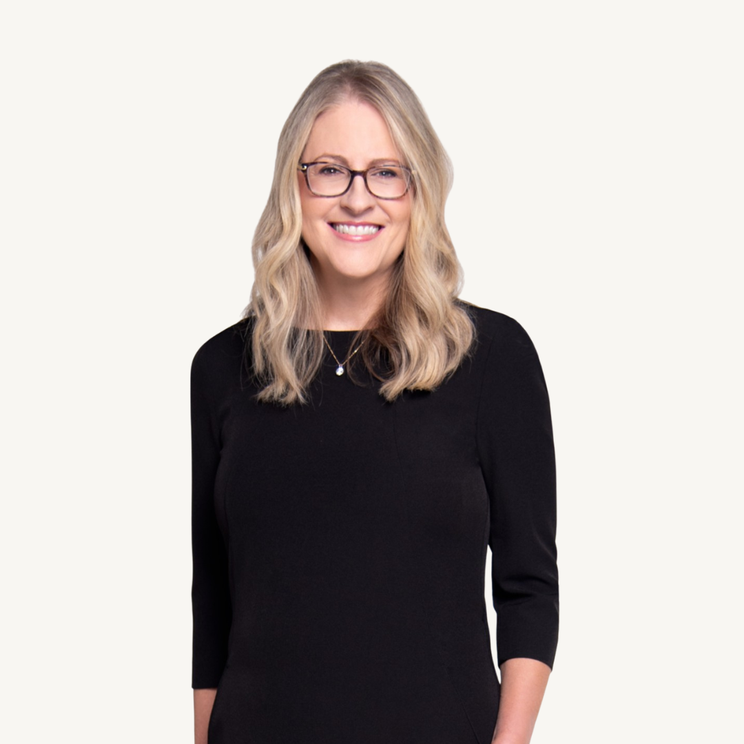 Karen Eber, founder of the Five Factory Settings of the Brain, smiling in a black dress