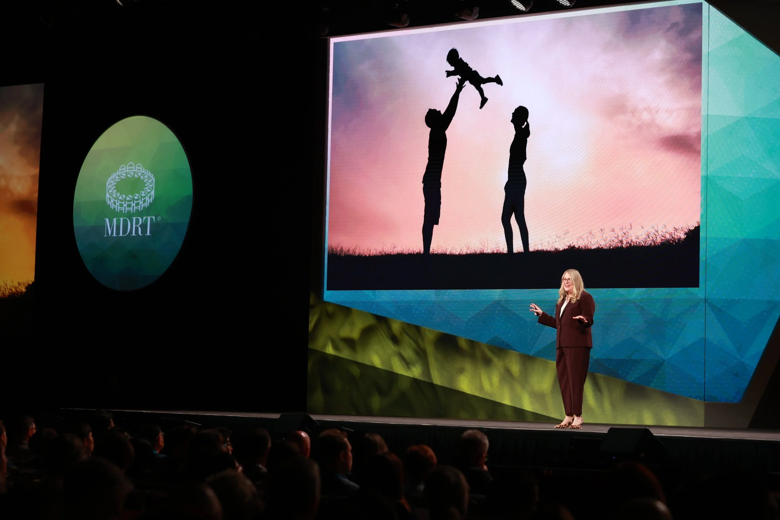 Karen Eber on a large stage providing a storytelling keynote