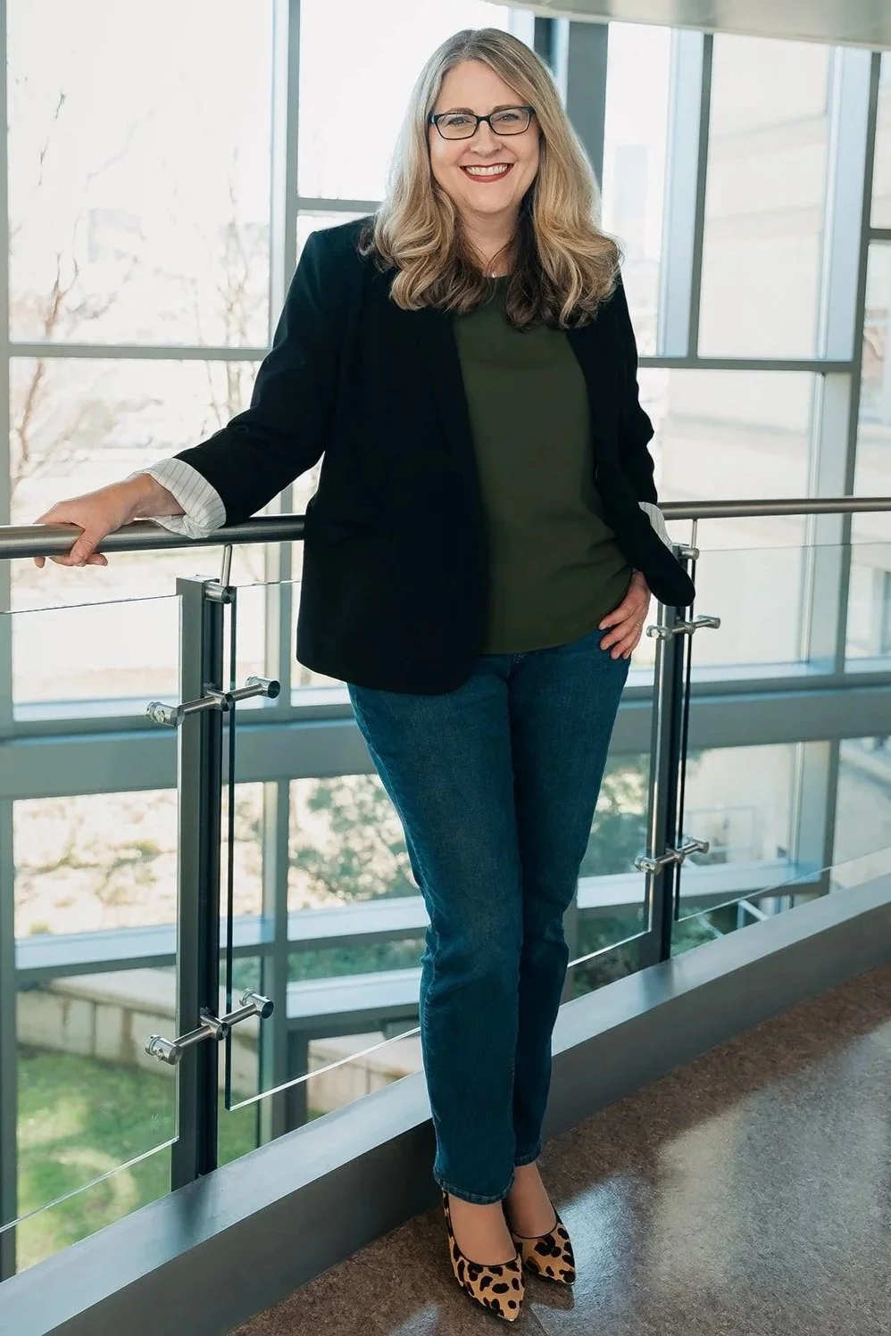 Storytelling Expert Karen Eber standing next to a railing and smiling
