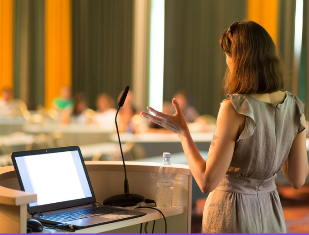 Woman speaking in front of a group