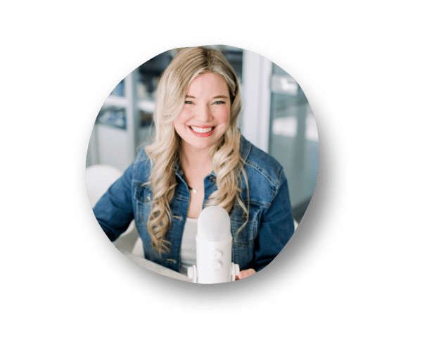 Danielle, a Business Collaboration Strategist, smiling while wearing a jean jacket with a white Blue Yeti mic in front of her.