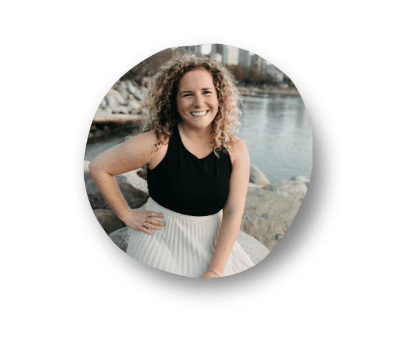 Close-up headshot of Lisa Michaud Wealth Building Coach and Real Estate Investor Entrepreneur, smiling with one hand on her hip and looking confident.