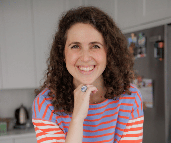 Close-up headshot of Frenchie Ferenczi, business strategist and advisor, smiling and looking confident.