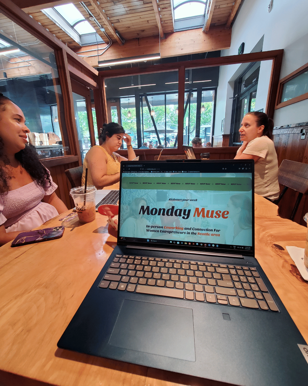 Women entrepreneurs coworking together during a Monday Muse gathering.