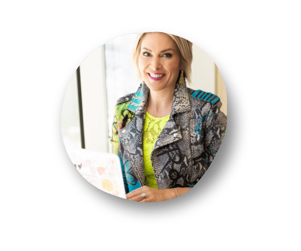 A smiling Chelsea Peitz, a Realtor Social Media Coach looking at the camera holding her laptop open and wearing a cool jacket.