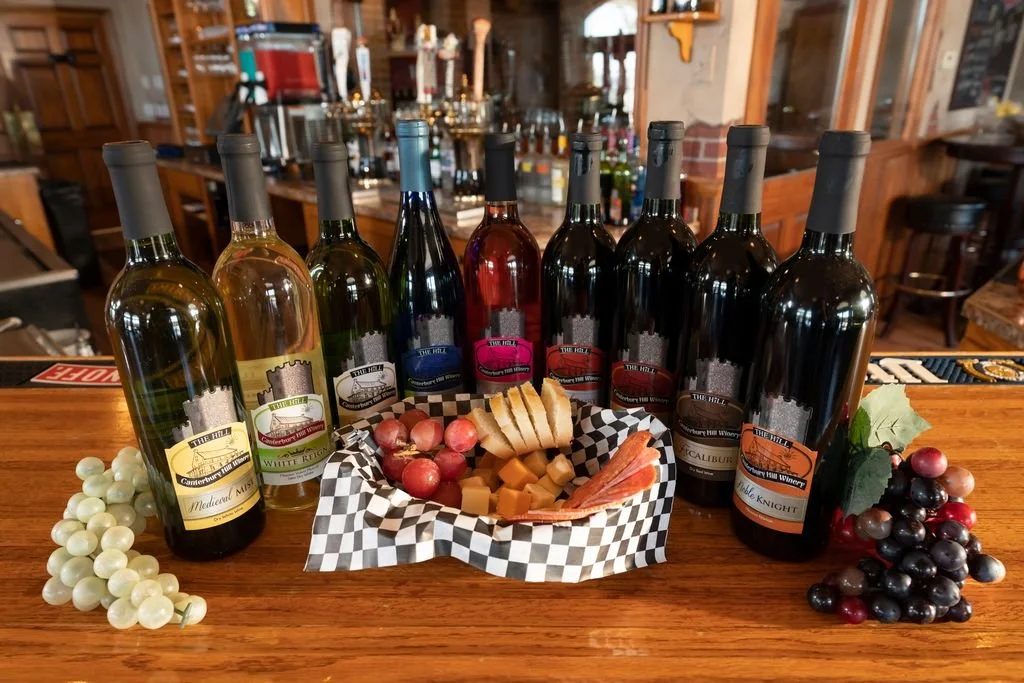 Local wines surround a basket of meat and cheeses