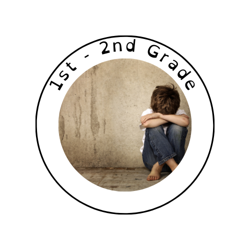 A child sitting against a concrete wall, hugging their knees with arms wrapped around them, wearing a white shirt and jeans.