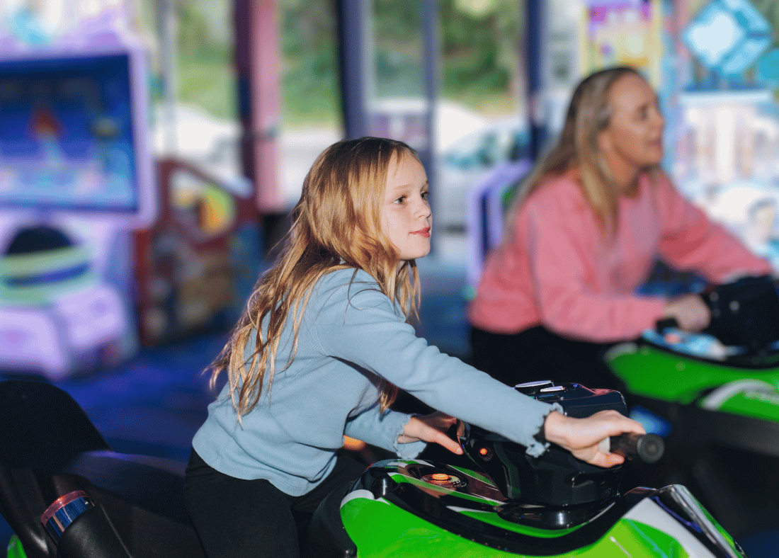 Mother and daughter playing driving motorbike game at Play2Win Palmy