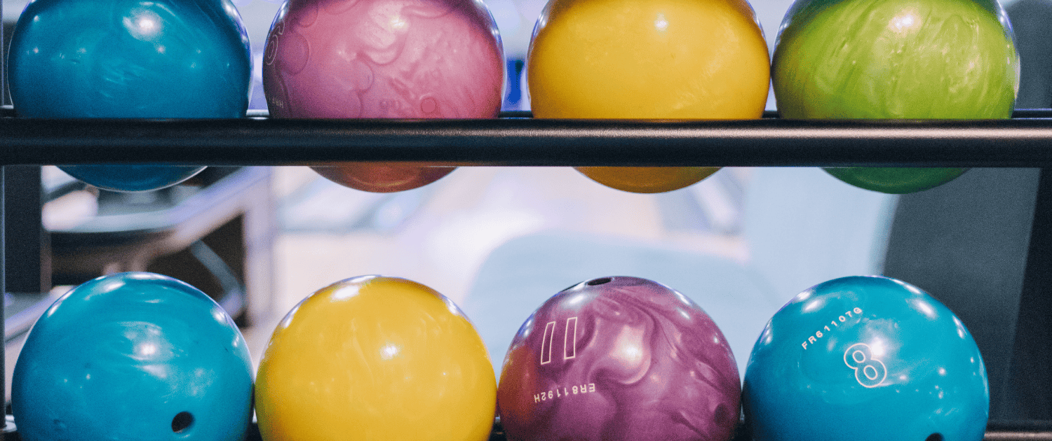 Two shelves of bowling balls at Play2Win Whanganui