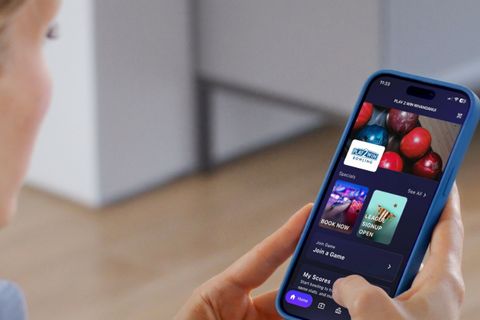 Women looking at Play2Win Bowling page on the Open Lane App on her phone