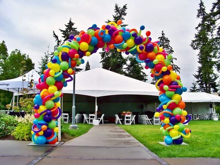 A stunning photo backdrop made from balloons in various colors and shapes, designed to fit an adult party theme