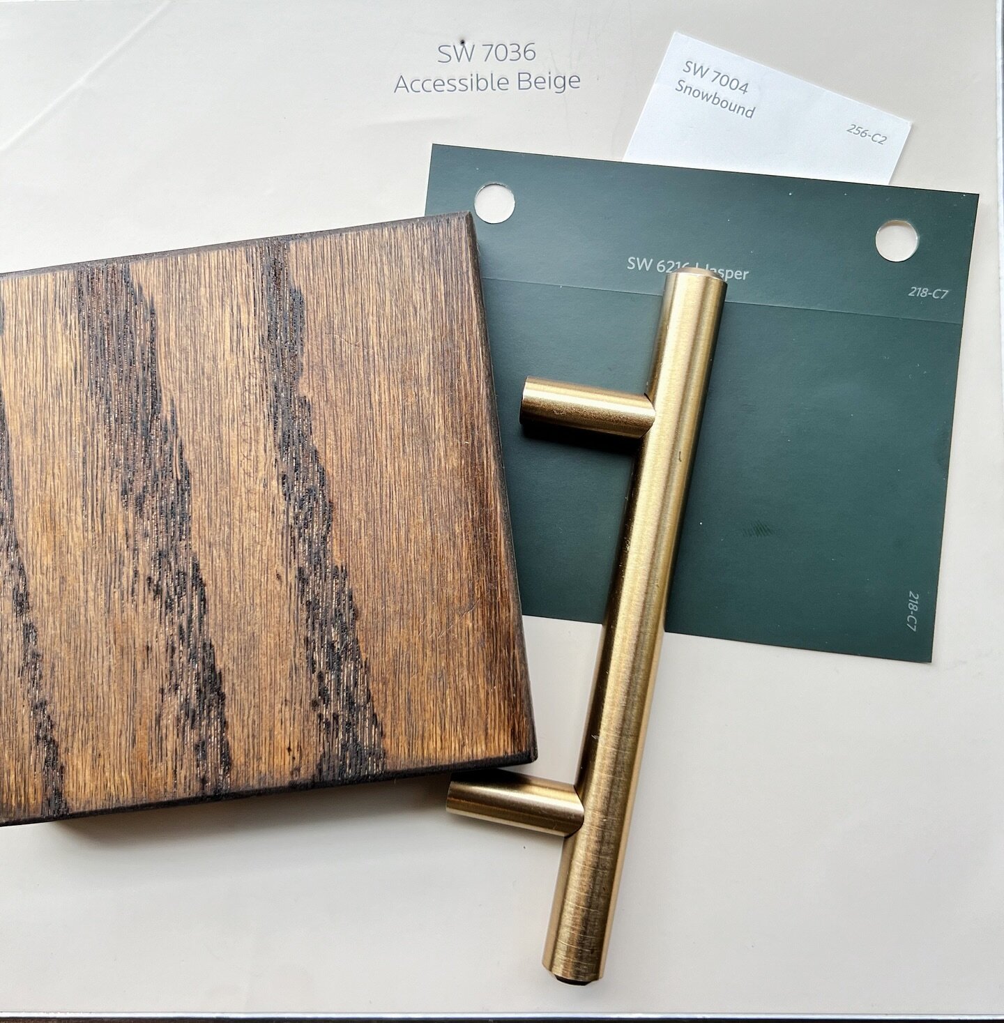 It may be April Fool&rsquo;s Day, but we don&rsquo;t joke about how much we love this flat lay. This dreamy combo of @sherwinwilliams Jasper cabinets, satin bronze (gold) hardware, rich wood tones and neutral walls is going to make this kitchen a stu